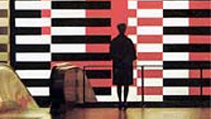 Silhouette of back of woman with knee-length coat standing in front of large mural painted with interlocking red, black, and white horizontal stripes