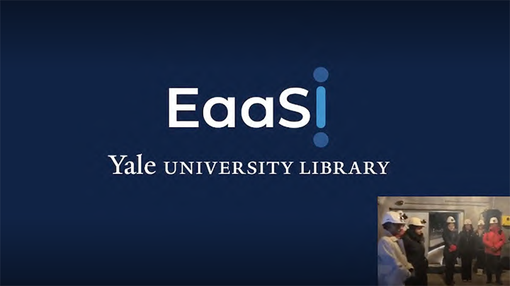 Blue ground with EaaSI and Yale University Library in white lettering with inset of six people in hard hats and coats gathered around the opening of a silver vault