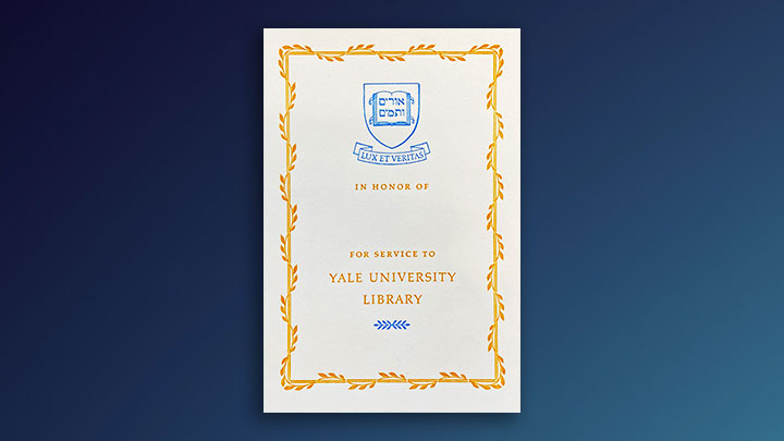 white book plate on dark blue background with gold border with intertwined gold leaf garden. Yale's openbook logo appears at top in blue with banner reading "Lux et Veritas" below. In gold lettering reads "In honor of" and "for service to Yale University Library"