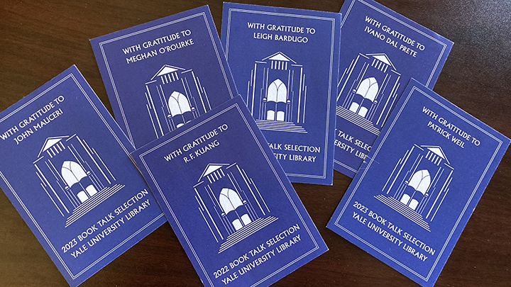 Six blue and white bookplates that read "With gratitude to" at top with each author's name; at bottom in white type reads "2023 Book Talk Selection, Yale University Library"; at center is a graphic depiction of the front of the library