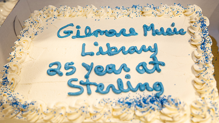 cake with white icing with "Gilmore Music Library 25 years at Sterling" written in blue icing