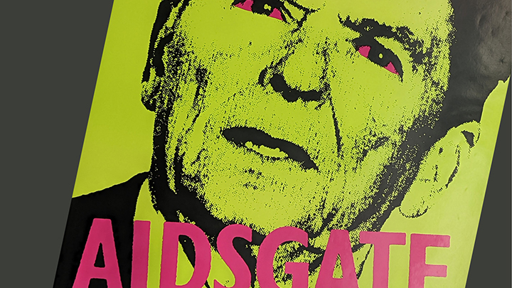 Detail of a poster showing former president Ronald Reagan's face in green with the word "AIDSGATE" printed in bright pink across the bottom, below his chin.