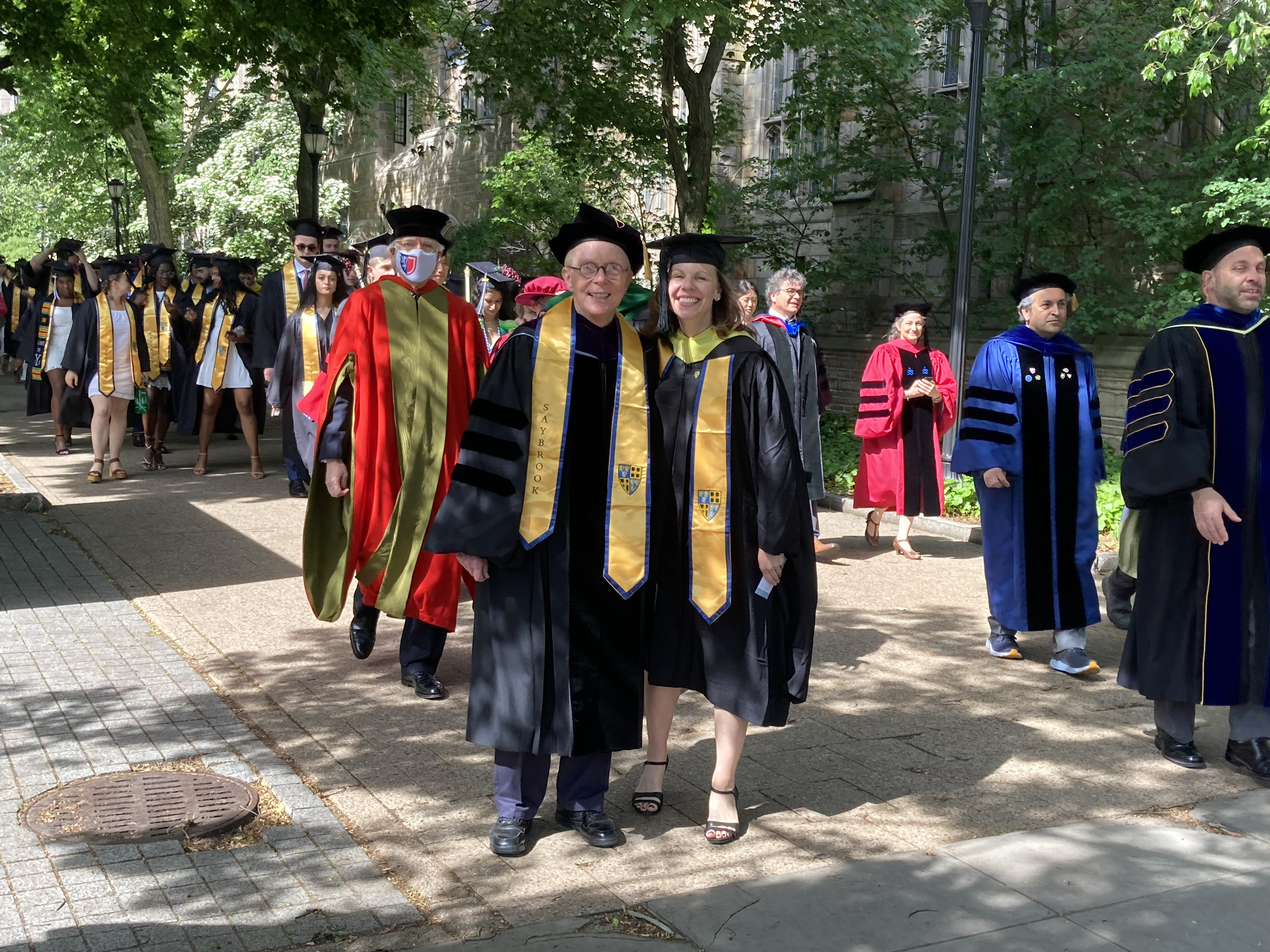 Procession of faculty and students with Fred Berg Yale Class of 66 and University Librarian Barbara Rockenbach in the foreground, wearing robes and caps