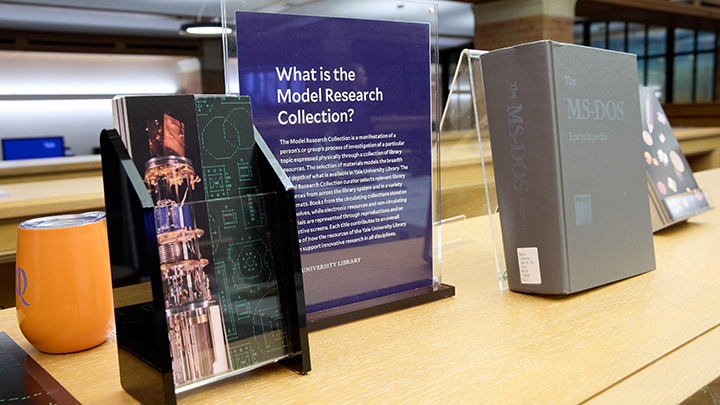 Dark blue display on book case that reads "What is the Model Research Collection" and large grey book titled The MS-DOS Encyclopedia"