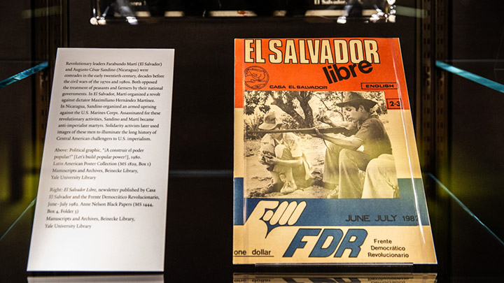 Red, white, and blue poster that reads "El Salvador Libre" with blue capital letters at bottom edge reading "FDR." A white label card with type sits to left of poster.