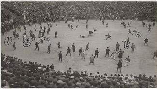 black and white postcard of people in a bullfight arena 