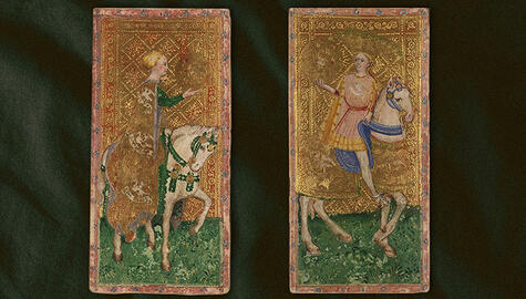 Two painted tarot cards, each showing a figure on a white horse, with backgrounds in gold geometric patterns