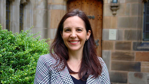 Color headshot of Michelle Light in the courtyard of Sterling Memorial Library