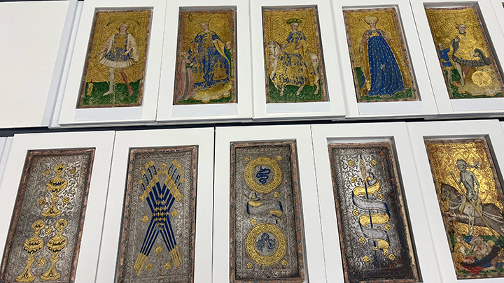 Ten cards in two rows of five showing medieval figures and symbols painted in blue silver and gold